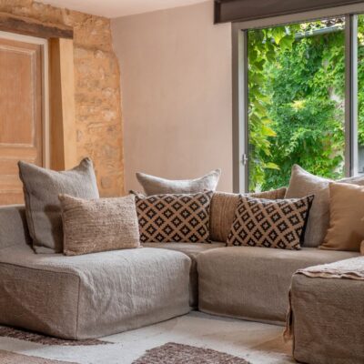 Coussin en raphia FLAIRS sur canapé en lin grosse trame de la ligne URBAN